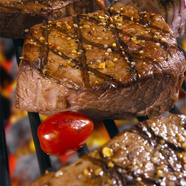 Close-up of steaks cooked over a barbecue grill